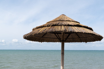 beach umbrella at tropical beach over blue sky