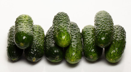 Beautiful young cucumbers on a white background