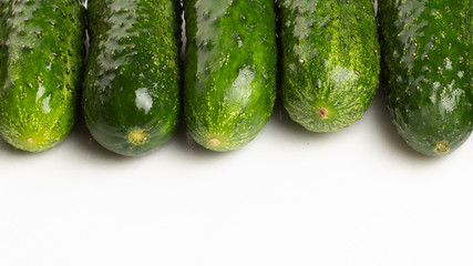 Beautiful young cucumbers on a white background