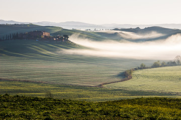 sunrise and fog over the hills in Tuscany