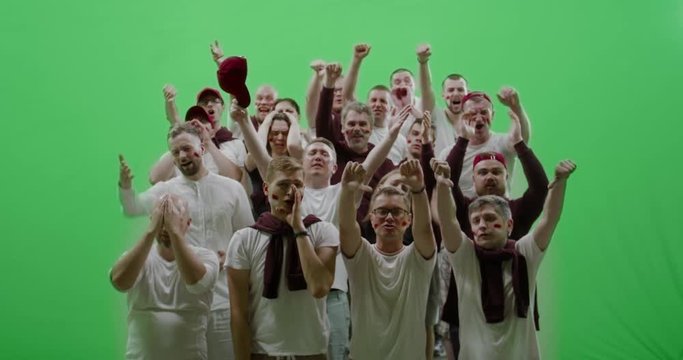 GREEN SCREEN CHROMA KEY Front view group of people fans wearing red clothes are outraged during a sport event. 4K UHD ProRes 422 HQ