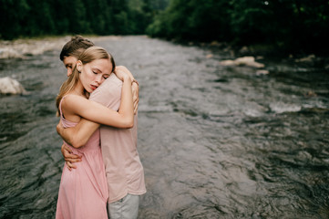 Lifestyle loving couple hugging in the river