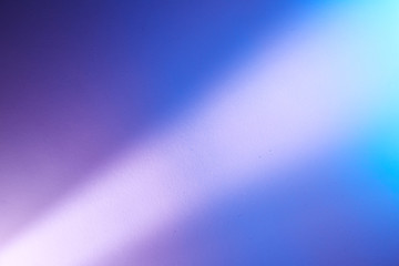 Fototapeta premium Intermittent light violet ray of light on a violet blue and light blue background