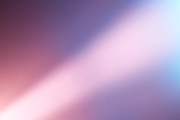 Light pink diagonal blurred ray of light on a pink and purple background