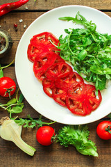 salad with tomatoes, arugula, balsamic sauce (fresh vegetables and salad dressing). Top view. copy space