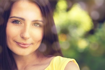 Young woman on field under sunset light