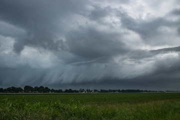 A shelfcloud of a severe thunderstorm over the wide open countryside of The Netherlands, western Europe. Severe weather is to be expected from this storm.