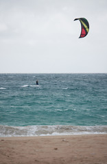 A kitesurfer in the distance off the coast of Uoleva in Tonga