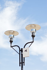 Lamppost on a cloudy sky background