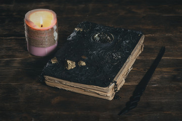 Book of magic and a magic wand on the magician table. Witchcraft.
