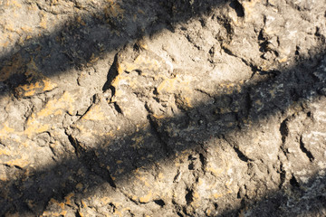 Uneven stone texture with diagonal shadow lines