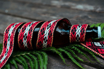 Latvian beer with traditional folk belt