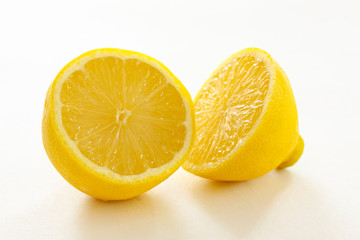 Two halves of a fresh organic lemon on white background - closeup Image