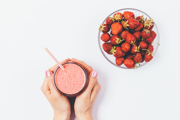 Female hands holding fresh pink strawberry