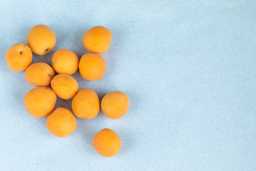 group of fresh apricots in a wooden bowl. healthy food 