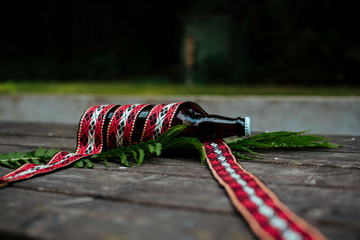Latvian beer with traditional folk belt
