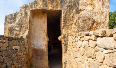 Cyprus. Pathos. Paphos Royal tombs. Tombs of the Kings. An ancient door leads deep into the ruins of sepulchers. The archaeological site of Paphos. Touristic sightseeing in Cyprus. Travel to Cyprus.
