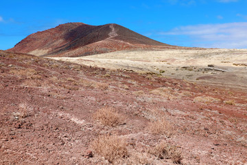 Path through red rocks mountains in El Medano, Tenerife, Spain