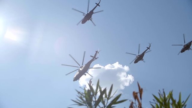 Helicopter on cloudy sky background. Military equipment.