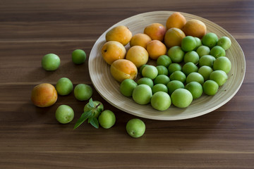plum and apricot fruits in the wooden plate for food photography concept or healthy life.
