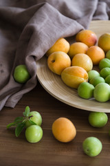 plum and apricot fruits in the wooden plate for food photography concept or healthy life.