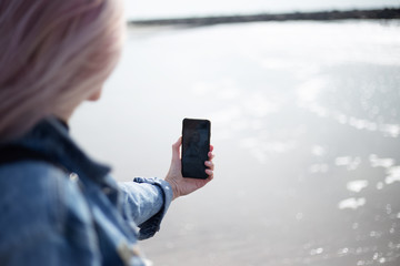 young girl taking selfie on the beach