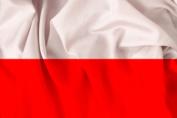 beautiful national flag of Poland on soft silk with soft folds, close-up, copy space