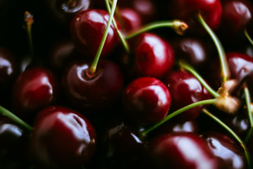 A closeup of red sweet cherries, lying close to each other. Selective focus.