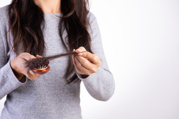 Healthy concept. Woman show her brush with damaged long loss hair and looking at her hair.