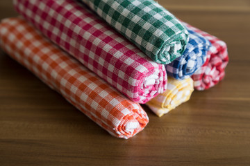 colorful,yellow,blue,orange,pink,red,green German napkins on the wooden table.