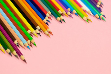 Close up of color pencils on pink background with clipping path. Education frame concept.