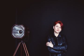 Red haired woman, sofa, arm-chair and silhouette on the window