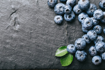 Fresh blueberry on stones background. Texture blueberry berries close up. Vegan and vegetarian concept.