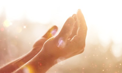 Hands of human praying on cross bokeh background
