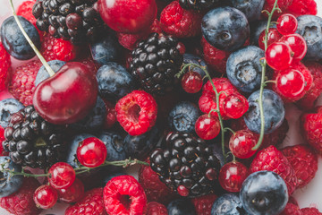 Fresh Summer Berries mix Background with Strawberry, Raspberry, Red currant, Blueberry and Blackberry.