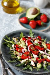 salad with strawberries and avocado, arugula, feta cheese, pumpkin seeds, red onion. dressed with balsamic sauce