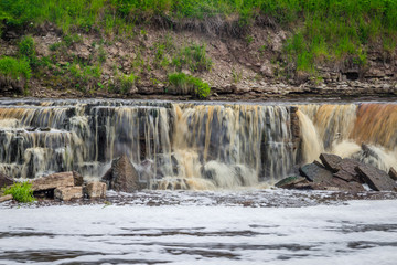 Sablinsky waterfalls. Little waterfall. The brown water of the waterfall.. Thresholds on the river. Strong water flow. Jets of water.