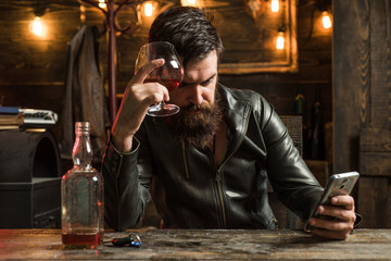 Drinking and party concept. Man drinks brandy or whiskey. Bearded man wearing suit and drinking whiskey brandy or cognac. Sommelier tastes alcohol drink. Degustation and tasting.