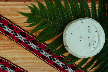 Latvian cheese with fern and national belt