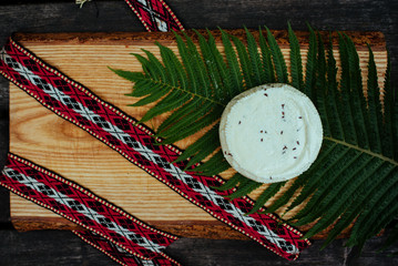 Latvian cheese with fern and national belt