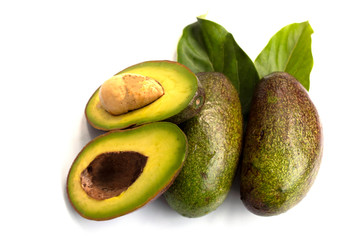 fresh avocado with leaves on white background