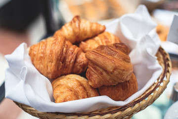 Beautifully decorated catering banquet table with variety of different pastry and bakery, with croissants and cookies on corporate christmas birthday party event or wedding celebration