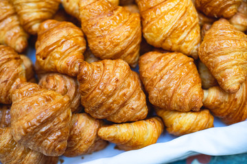 Beautifully decorated catering banquet table with variety of different pastry and bakery, with croissants and cookies on corporate christmas birthday party event or wedding celebration