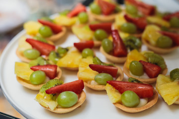 Beautifully decorated catering banquet table with assortment variety of different food snacks and appetizers on corporate christmas birthday party event or wedding celebration