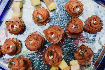 Beautifully decorated catering banquet table with assortment variety of different food snacks and appetizers on corporate christmas birthday party event or wedding celebration