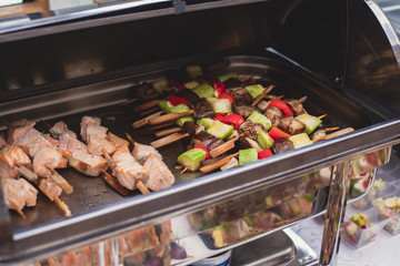 Beautifully decorated catering banquet table with assortment variety of different food snacks and appetizers on corporate christmas birthday party event or wedding celebration