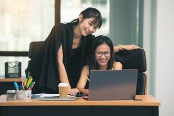 Two young asia business woman working together in office space