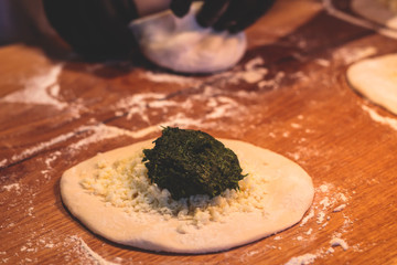 Process of cooking and serving traditional georgian food cuisine, with pkhali khinkali dumplings and khachapuri