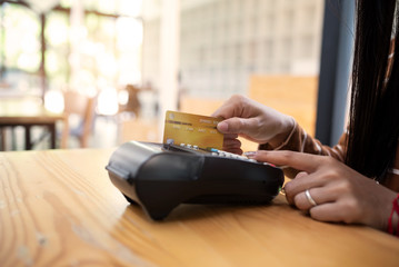 Obraz premium Young asian girl using credit card make a payment.