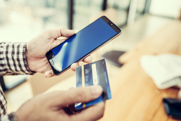 Young man hand holding a credit card.